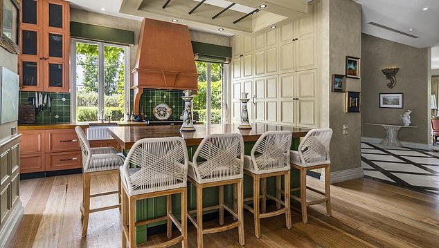 Located in Brighton in Melbourne, the sprawling home features four bedrooms and three bathrooms Pictured: One of several dining rooms