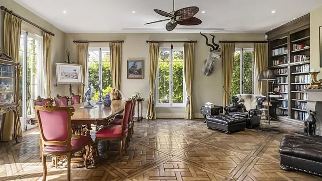 Highlights include a mansard slate ceiling and the use of French oak, cast iron and Venetian plaster throughout Pictured: A formal dining room with library