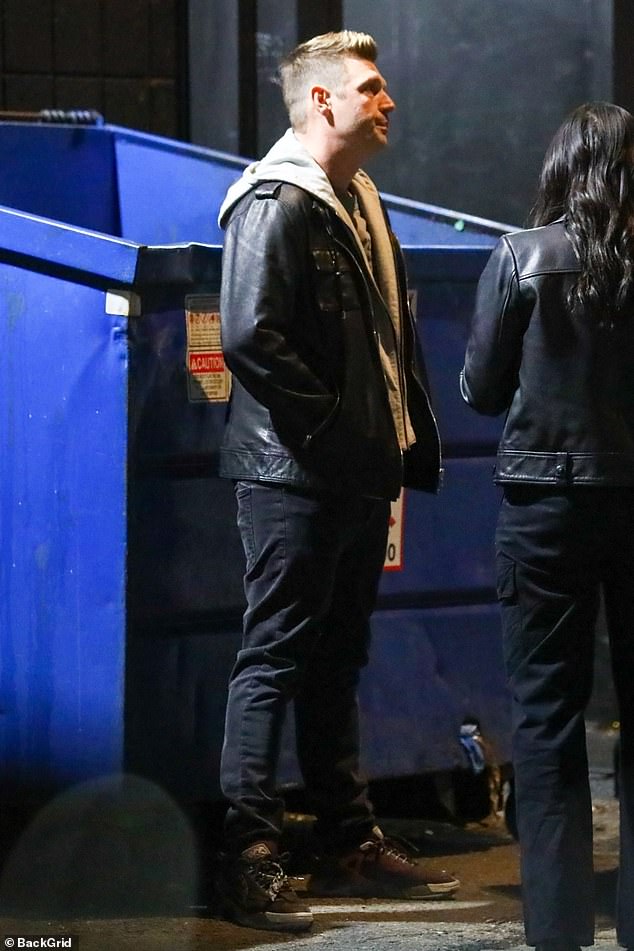 Casual: Nick rocked a casual gray hoodie under a black leather jacket for the event  The As Long as You Love Me hitmaker paired the look with black jeans and matching sneakers.