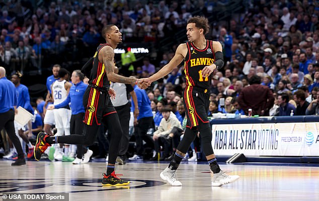 Dejounte Murray (5) celebrates with guard Trae Young during the game against the Mavericks