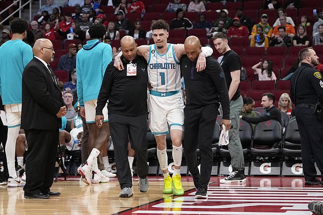 LaMelo Ball (1) is helped off the court after injuring himself against the Houston Rockets