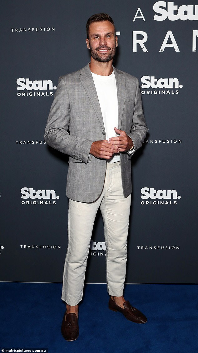 Beau Ryan looked stylish in a gray blazer and white T-shirt.  He combined his look with white pants and brown shoes.