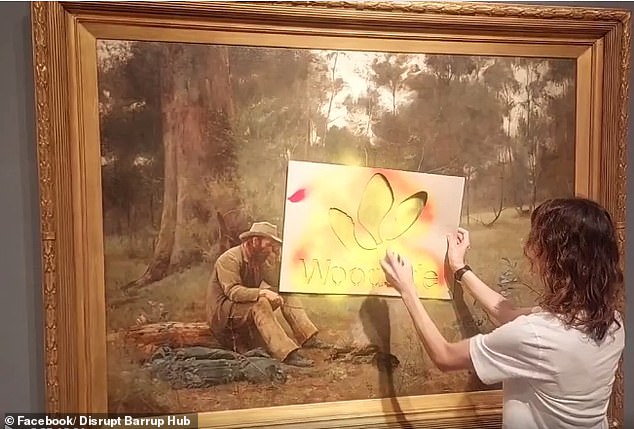 Partyk sprayed Woodside's logo on the iconic painting (above), which is estimated to be worth $3 million, while Blurton placed an indigenous flag in front of them.
