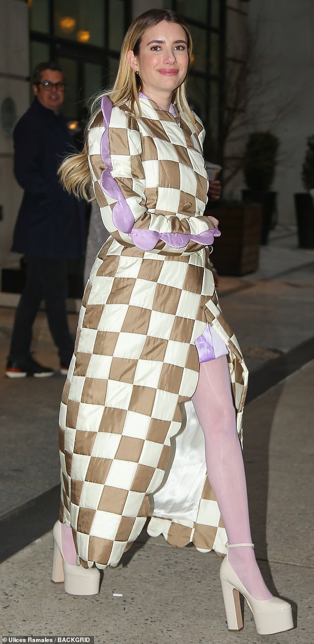 The Look: Over the top of the dress, the Wild Child star wore a long cream and brown plaid coat with funky purple piping detailing on the arms.