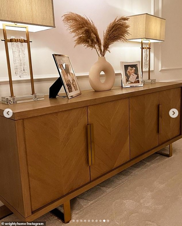 Pride spot: A sideboard with photos of the couple on their wedding day in 2015, supported by two cream-colored lamps.