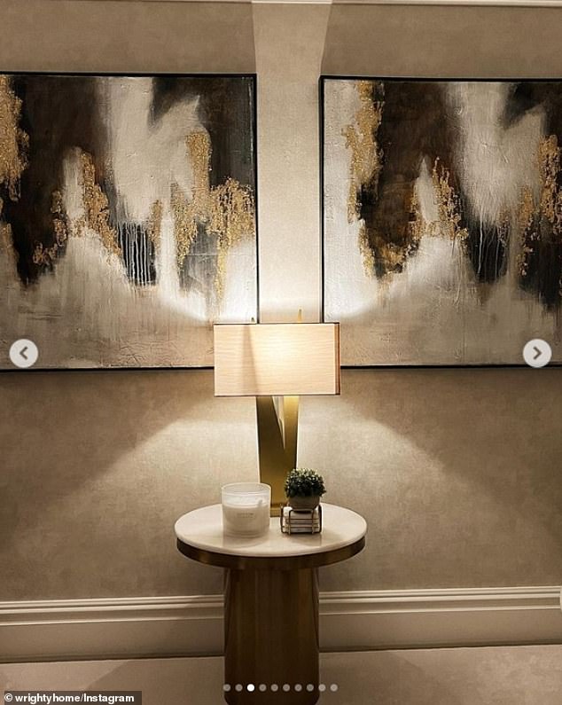 Artwork: The gray colored walls were decorated with two large abstract paintings with hints of gold for an added touch of style.