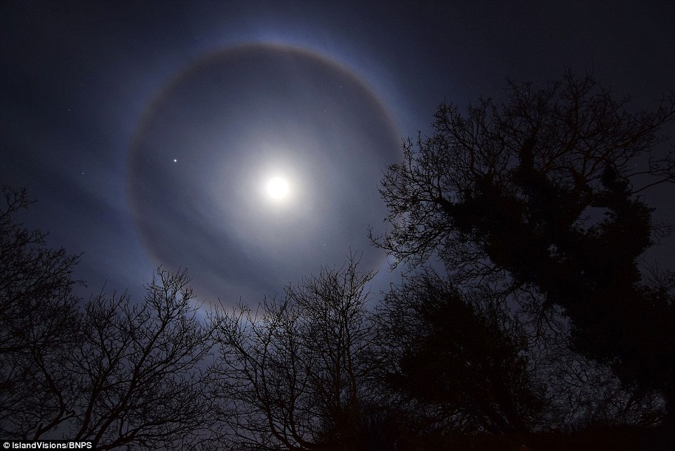 Pictured is the moon halo over the, Isle of Wight. The moon halo is formed by a high-altitude ice crystal cloud that gathers around the moon