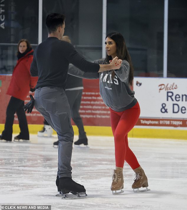 Simple look: While his partner Brendyn rocked a pair of gray pants with a black hoodie as he guided the star along the ice.