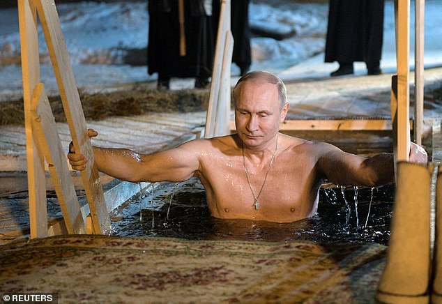 Russian President Vladimir Putin dives into the water during Orthodox Epiphany celebrations in Lake Seliger, Tver region, Russia, January 19, 2018.