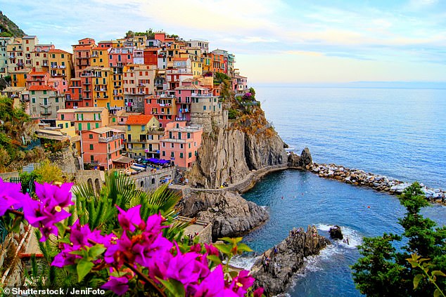 The average package holiday cost in Italy has risen by 23 per cent to £757. Pictured is the pretty Italian town of Manarola