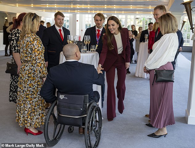 The 41-year-old mother of three once again donned a burgundy Roland Mouret suit for this afternoon's special occasion.