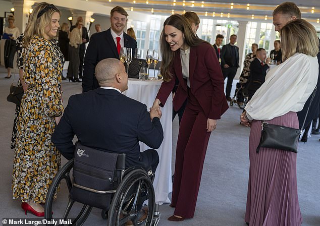 The Princess of Wales shook hands with a guest at her reception at Hampton Court Palace.