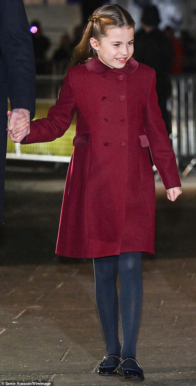 Princess Charlotte, 7, was her mother's mini-me and donned her own burgundy coat as she stepped out to attend the Christmas carol service tonight.