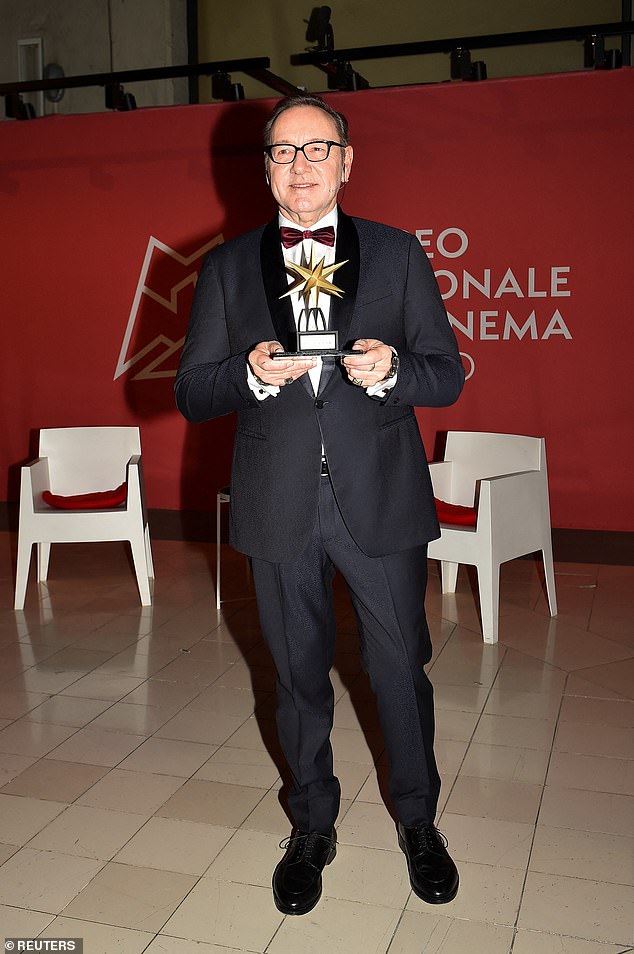 In suit and boots: Kevin dressed in a classic black tuxedo and red bow tie for the occasion in Turin