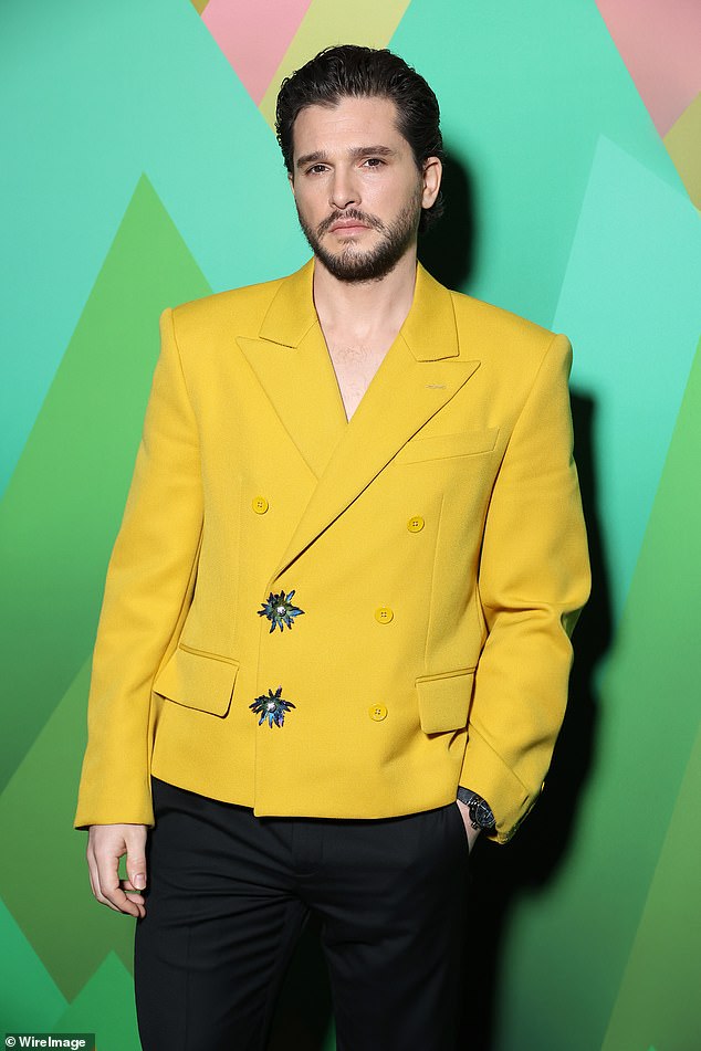 Suave: Kit, meanwhile, who welcomed her first child with Rose in 2021, showed off a sleek figure in a mustard yellow blazer as she proudly posed with her wife ahead of the fashion show