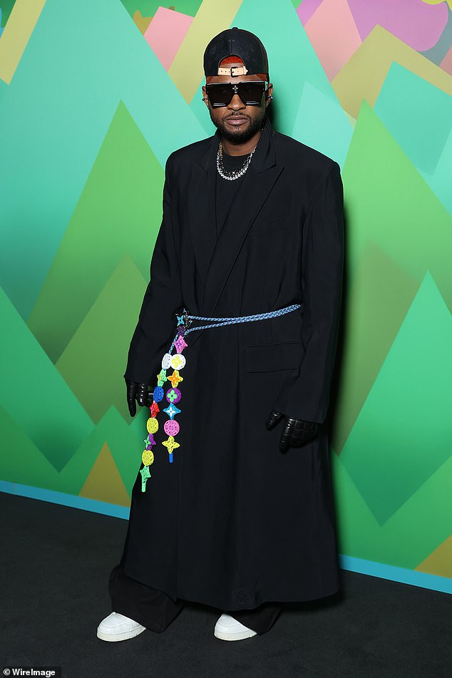 Fashion star: Usher also made a bold entrance with his own funky noir style.