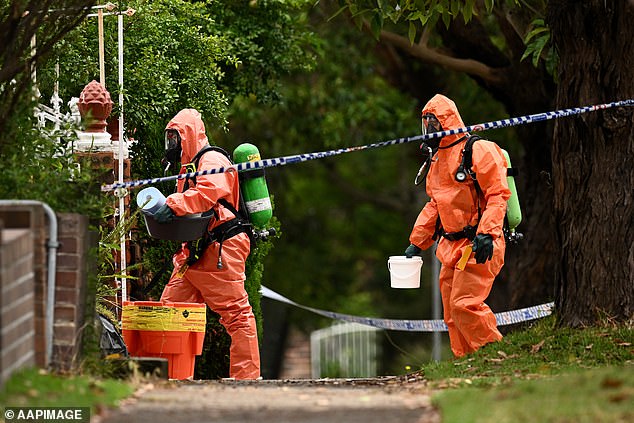 Fire and Rescue NSW was called to the Roselands house after two police officers suffered burns from hydrochloric acid (Pictured, Fire and Rescue NSW officers cleaning the house)