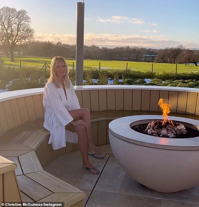 Spa day: The star also donned a white robe as she took in the stunning view at the spa while relaxing by a fire pit