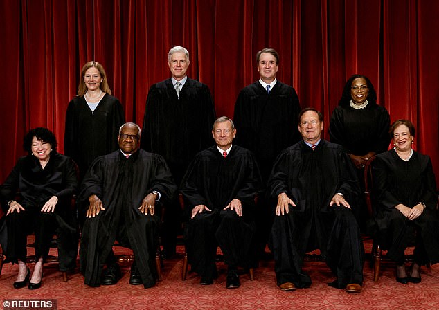 The Justices of the US Supreme Court: Seated (L-R): Justices Sonia Sotomayor, Clarence Thomas, Chief Justice John G. Roberts, Jr., Samuel A. Alito, Jr., and Elena Kagan.  Standing (L-R): Judges Amy Coney Barrett, Neil M. Gorsuch, Brett M. Kavanaugh and Ketanji Brown Jackson