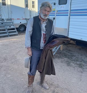 Alec Baldwin is seen on the set of Rust wearing fake blood early Thursday, hours before he shot and killed the film's cinematographer.  He shared this photo on Instagram with the caption "Come in person at the office.  Wow, it's exhausting." Filming was halted after the fatal incident on the Bonanza Creek Ranch film set in Santa Fe.