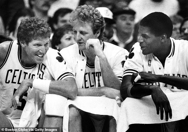 From left, Boston Celtics' Bill Walton, Larry Bird and Robert Parish laugh on the sidelines in the final minutes of the game.  The Boston Celtics host the New York Knicks in an NBA regular season basketball game at the Boston Garden on March 15, 1987.