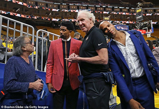 Former NBA player and current ESPN analyst Richard Jefferson (right) takes a photo of the scene leaning his head over NBA great Bill Walton (second from right) as he watches a photographer shooting Walton with Mickey Hart (far left) of the Grateful Dead as he speaks.  with former NBA player and current media personality Jalen Rose (second from left) about two hours before kickoff.  The Boston Celtics visited the Golden State Warriors for Game One of the NBA Finals at the Chase Center in San Francisco, CA on June 2.  Jefferson is a family friend of Walton's and played with the 70-year-old son, Luke, at the University of Arizona.