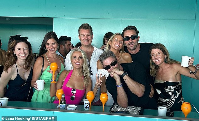 Michael Clarke, (second right front in black shirt) with New Year's Day revelers at Bondi Icebergs, which he was expected to attend with Yarbrough, who was instead in Aspen.