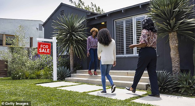 Pictured: A couple of people being shown a property (file photo)