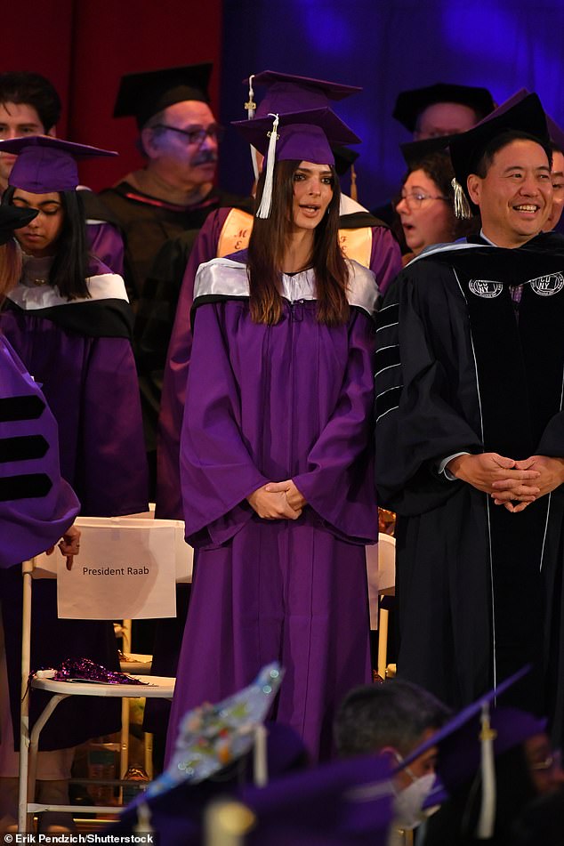 1674172948 261 Emily Ratajkowski dons a purple cap and gown while delivering