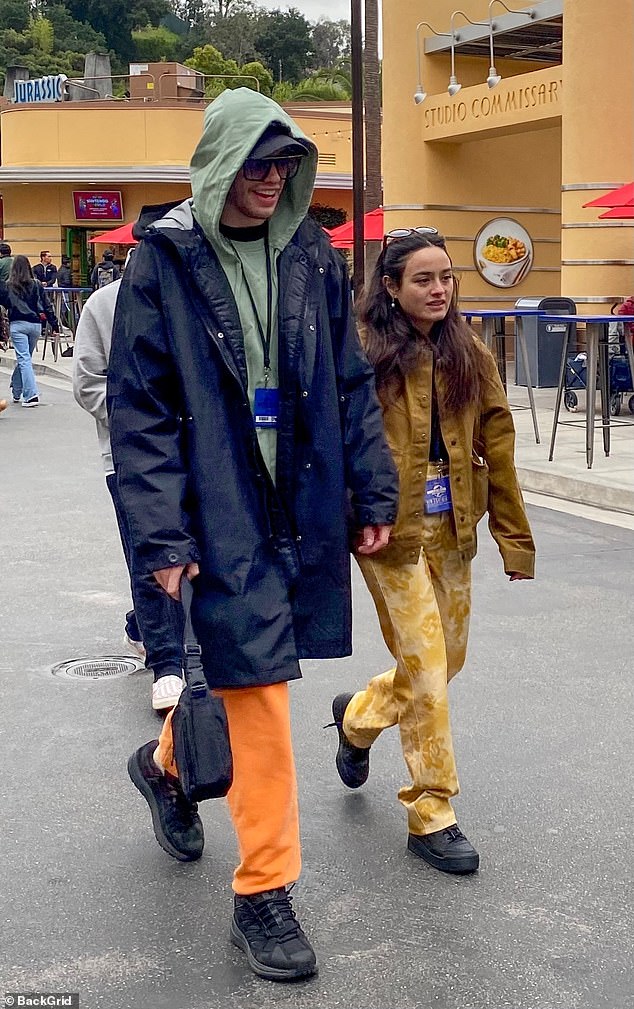 Casual Cool: Meanwhile, Chase kept it casual in a brown jacket, which she paired with floral yellow pants and black sneakers