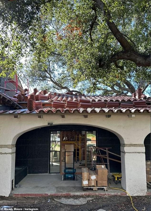 New roof: Alongside a photo of her home with new roof tiles, the 47 Meters Down star wrote: 'We're still in New York for a few months but work at home is progressing.  It's been almost 3 years since we bought this place so we are VERY excited'