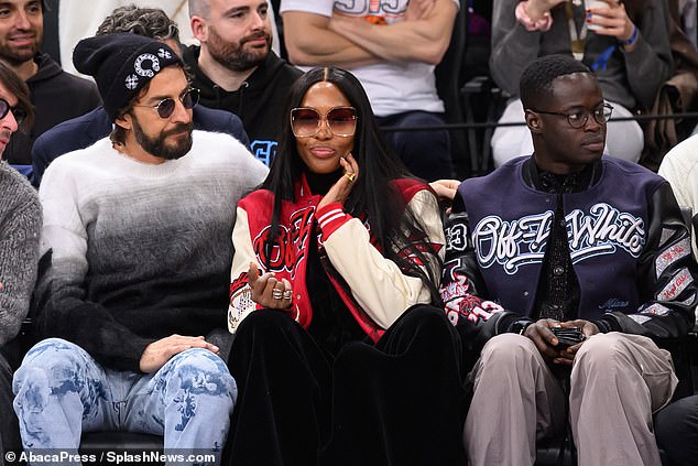 Matching: His stylish pal's matching dark blue Off-White baseball jacket was a perfect contrast to Naomi's, and the pair held hands as they chatted.