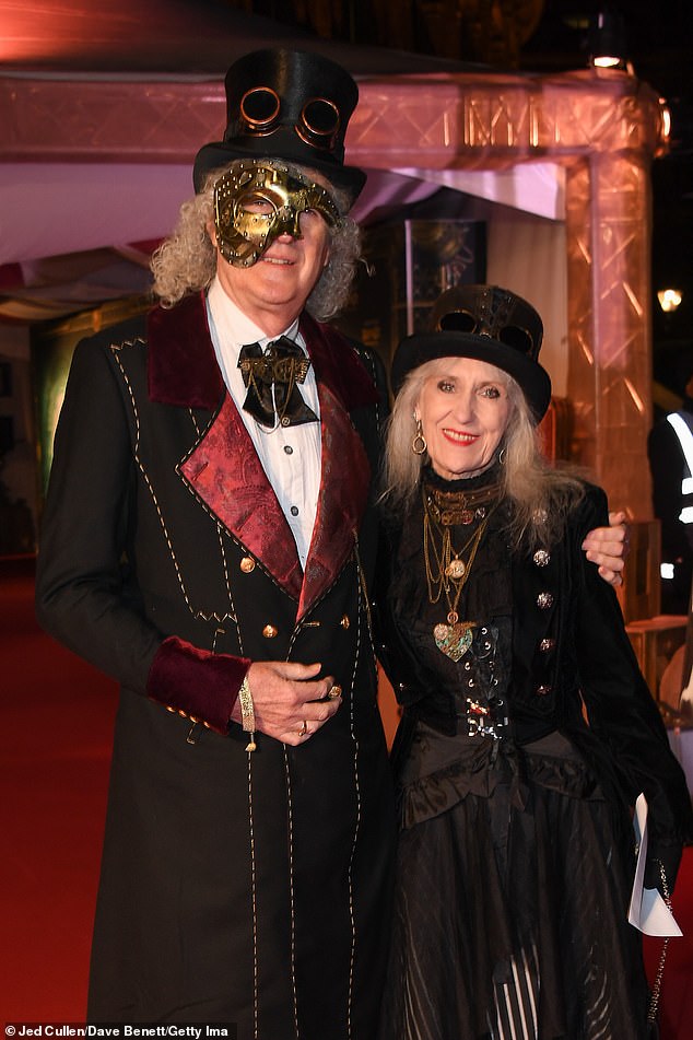 Queen guitarist Sir Brian May and his wife, former EastEnders star Anita Dobson, looked like cast members as they turned up to see Cirque Du Soleil's latest show, Kurious, at London's Royal Albert Hall.