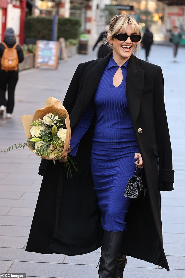 Wow!  The 41-year-old singer cut a trendy figure in a navy blue midi dress, which she teamed with a pair of leather boots.