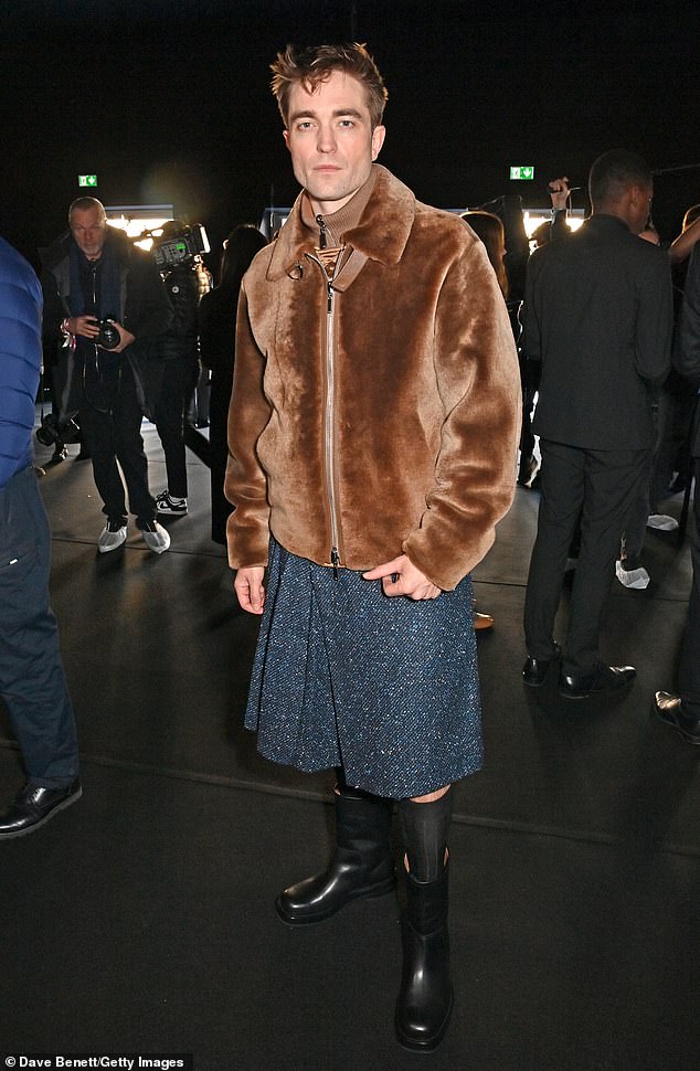 Pose: The actor looked stylish as he modeled a navy tweed skirt which he paired with a brown fur bomber jacket