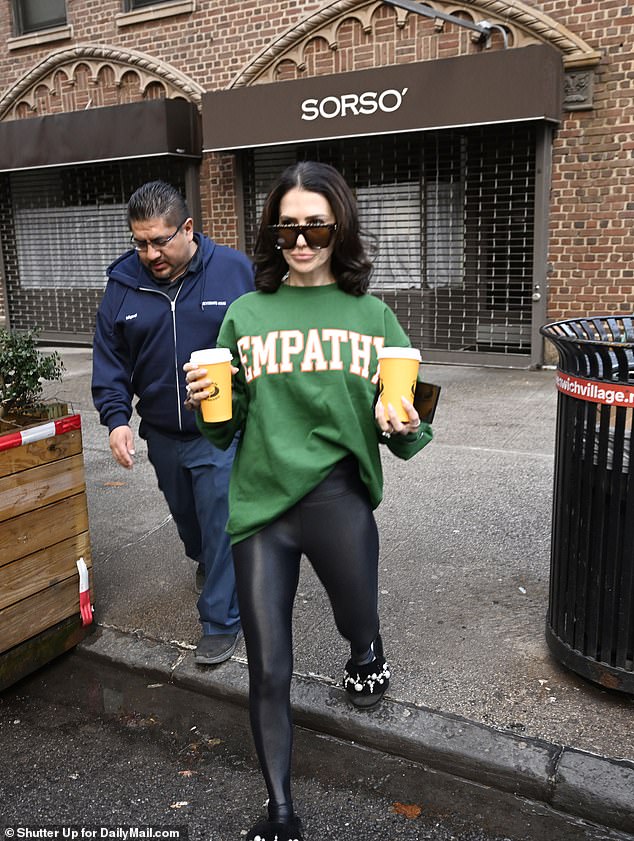 Hilaria wore a green sweatshirt with 'EMPATHY' - valued at $108 - printed on the front, as she looked pale and put on large dark glasses to cover her face Hilaria wore a green sweatshirt with 'EMPATHY' - valued at $108 - printed on the front the front, as she looked pale and she put on large dark glasses to cover her face