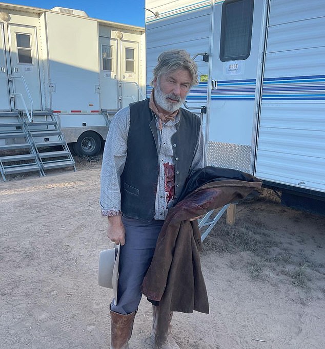 Alec Baldwin is seen on the set of Rust wearing fake blood early Thursday, hours before he shot and killed the film's cinematographer.  He shared this photo on Instagram with the caption "Come in person at the office.  Wow, it's exhausting." Filming was halted after the fatal incident on the Bonanza Creek Ranch film set in Santa Fe.