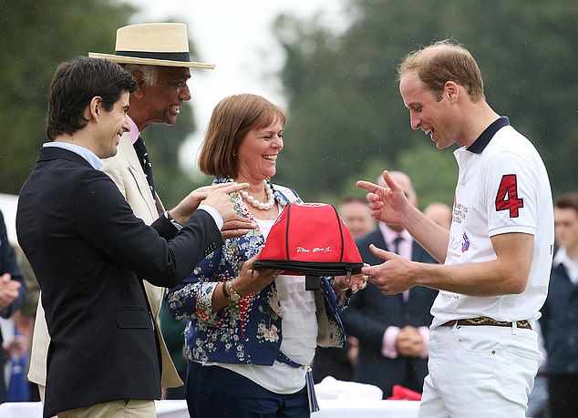 Ignacio Archain, far left, Kuldip Singh Dhillon and Gachi Ferrari present Prince William with the La Martina Pro Evolution helmet for the most valuable player of the match in 2014