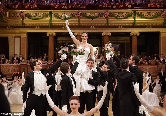 The center dancer smiled as her dance partner lifted her up and leaned on her shoulders while holding her corsage.