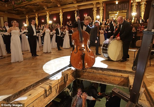 Do not let him fall!  The orchestra's instruments are passed around the dance floor after the opening performance.