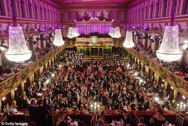 A high shot of the ballroom shows guests descending on the dance floor after the debutantes' performance.