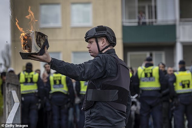 Far-right activist Rasmus Paludan burns a Koran during an election meeting in May 2022