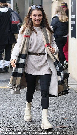 Winner: Raining champion Jowita Przystal looked stylish in a cream coat and layered a sweater.