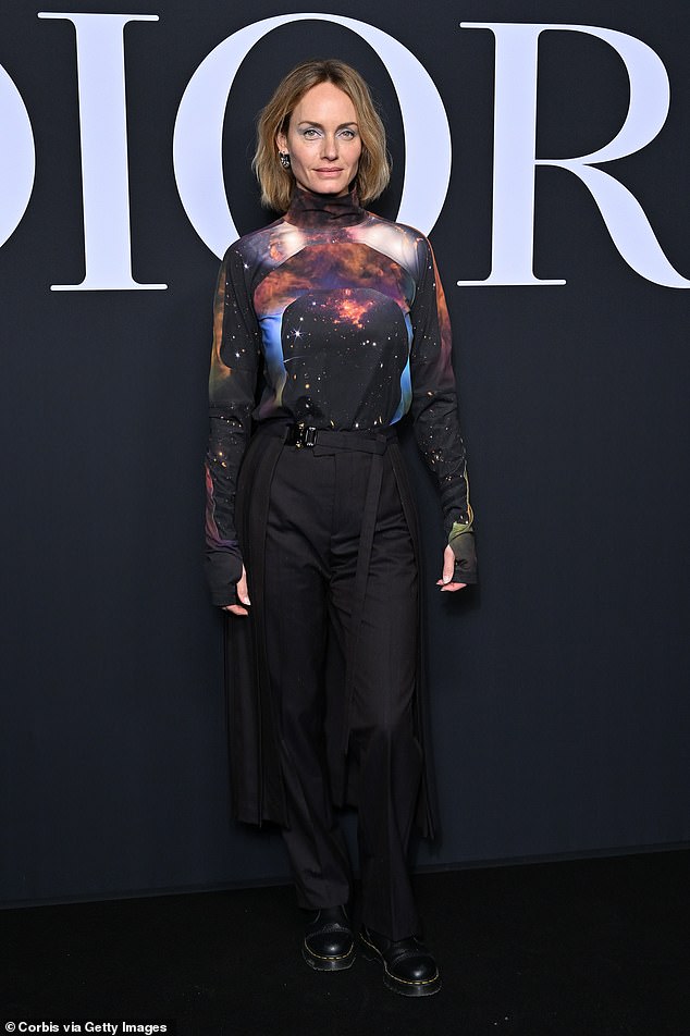 Striking: Amber donned a striking constellation-print shirt which she paired with high-waisted black pants and chunky patent leather boots