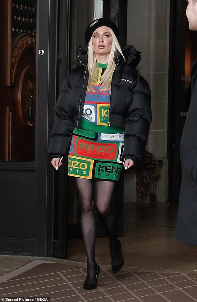 Meanwhile, her longtime friend rocked a Kenzo minidress, black puffer jacket, and beret.  a pair of semi-sheer tights and a stunning pair of high heels