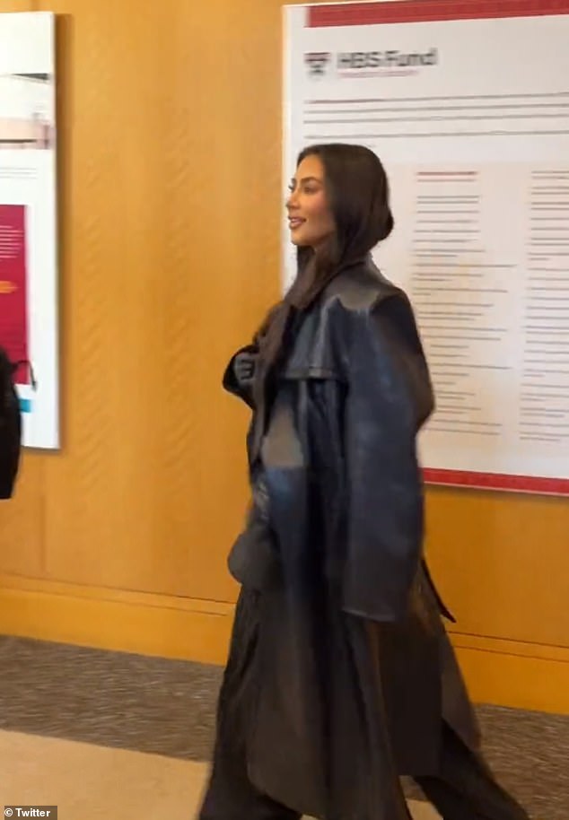 Back in black: Kim looked smart and business-ready in a black pinstripe suit with wide leg pants and a matching blazer, along with a black leather smock over the shoulders