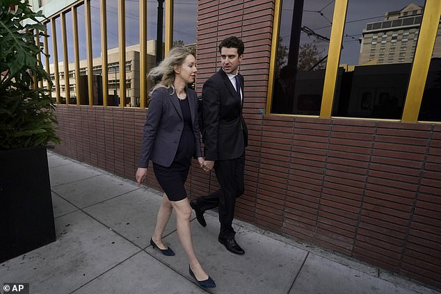 Former Theranos CEO Elizabeth Holmes, left, walks with her partner, Billy Evans.