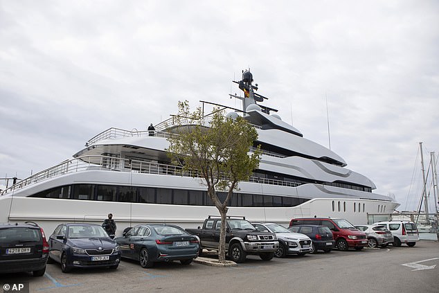 A civil guard stands next to the yacht named Tango in Palma de Mallorca, Spain, Monday, April 4, 2022, as FBI agents search and seize the vessel.