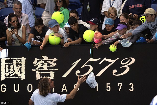 Tsitsipas signs autographs after his third round win against Tallon Griekspoor of the Netherlands