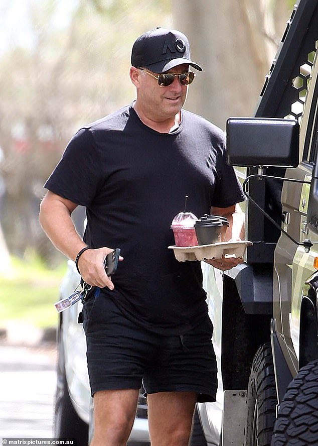 The 48-year-old Today show host smiled but remained focused as he carried a tray containing two takeaway coffees and a pink milkshake.